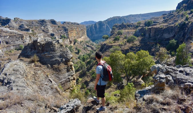 Nomade Matt nel Parco Nazionale Isalo, Madagascar che guarda la valle e le foreste